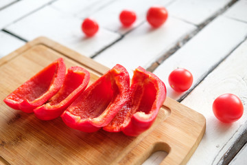 Vegetables lie on a table on a chopping board