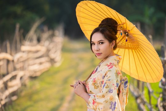 Japanese women wear kimono holding umbrellas 
