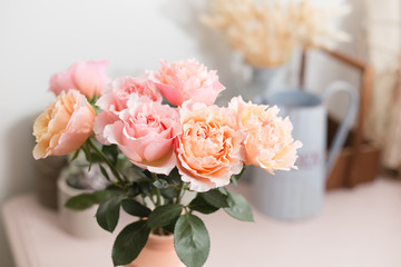 Bouquet flowers of pink roses in glass vase. Shabby chic home decor. florist at a flower shop.