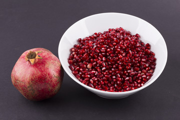 Pepper in the plate pomegranate black background