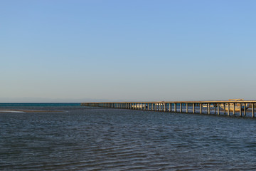 Fototapeta na wymiar Long pier in the sea evening