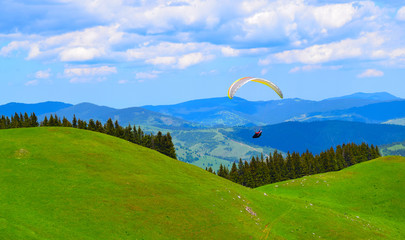 Paraglider above a mountain pasture landscape, Transylvania