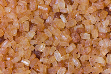 Brown sugar crystals closeup as texture.