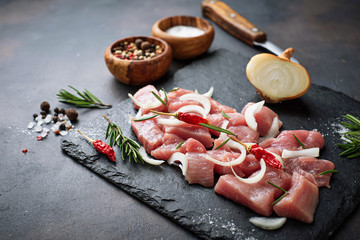 Raw chopped meat with spices on rusty background