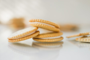 A round cookie with white filling on a light background