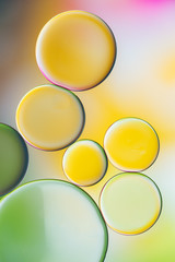 drops of oil and air bubbles on the water