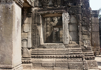 Fototapeta na wymiar Carved Stone images on Bayon Temple ruins, 12th century, in Angkor Wat, Siem Reap, Cambodia