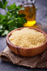Couscous grain in wooden bowl 