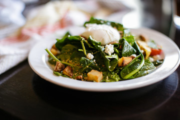 poached egg over wilted greens