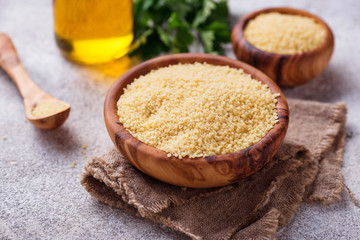 Couscous grain in wooden bowl 