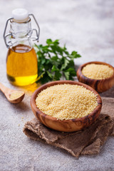 Couscous grain in wooden bowl 