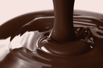 Pouring liquid hot chocolate closeup. Cooking dessert.