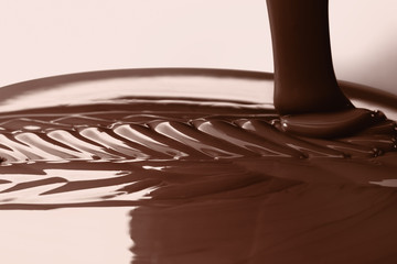 Pouring liquid hot chocolate closeup. Cooking dessert.