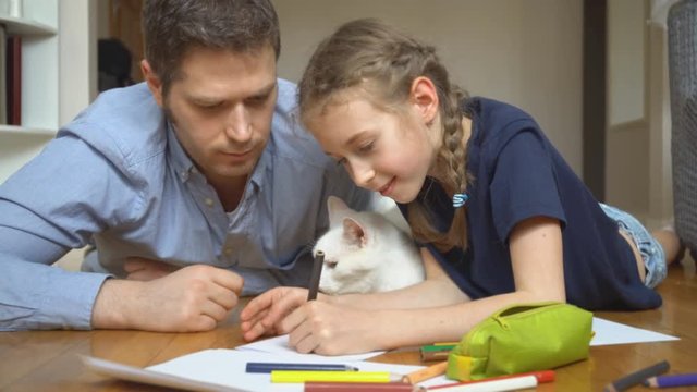 Family with cat drawing on the floor.