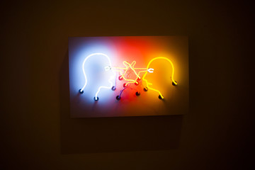 Face shaped neons lighted in dark area.