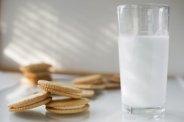 miscellaneous cookies, next to milk on a soft light background