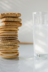 miscellaneous cookies, next to milk on a soft light background