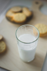 miscellaneous cookies, next to milk on a soft light background