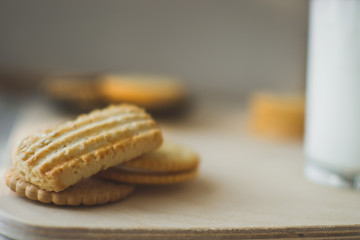 miscellaneous cookies, next to milk on a soft light background