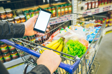 man look into phone for a shopping list