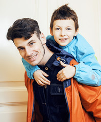 young handsome father with his son fooling around at home, lifes