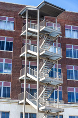 Vertical shot of a fire escape on the outside of a building.
