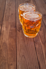 Beer mugs on wooden bar benches.