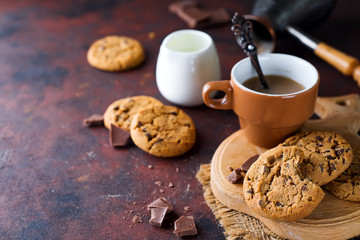 Chocolate cookies in plate and cup of hot coffee