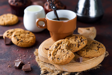 Chocolate cookies in plate and cup of hot coffee