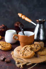 Chocolate cookies in plate and cup of hot coffee