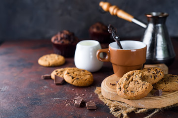 Chocolate cookies in plate and cup of hot coffee
