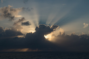 Naklejka na ściany i meble Cloudy sunset over the Caribbean Ocean