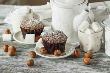 Cups with cacao and marshmallow, cupcakes and different decorations