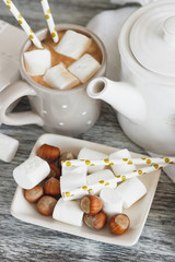 Cups with cacao and marshmallow and different decorations