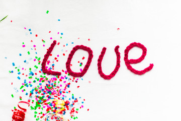 Inscription in knitted letters on a white background. St. Valentine's Day isolate