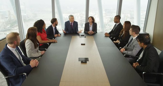 4k, Large Group Of Multi Ethnic Business People In A Board Room Meeting With London Skyline In The Background. Slow Motion.