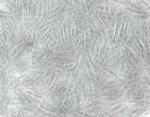 Close up of paperclips on white background with shadow reflection.