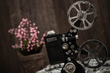 Small nostalgic decorative film camera on brown wooden background