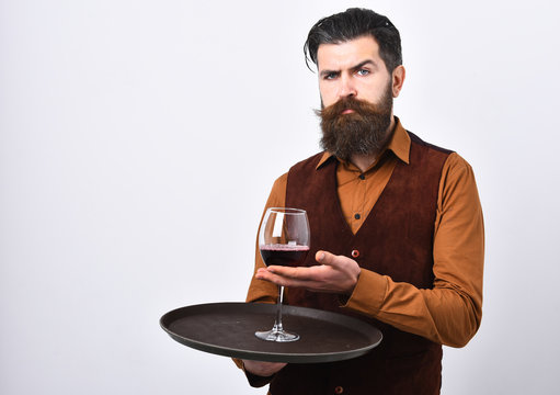 Man with beard and mustache holds alcohol on white background