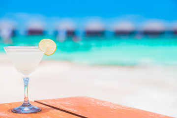 glass of delicious cold cocktail by the beach