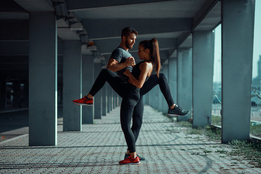 Young sports couple exercising in the urban environment