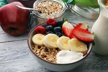 muesli with dairy and fruit, healthy lifestyle. bowl of cereal, fruit and dumbbell