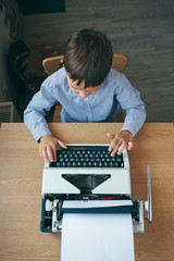 Fototapeta na wymiar Boy with typewriter