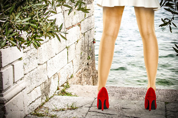 slim woman legs and red heels 