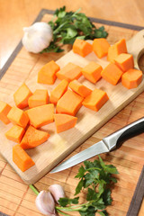 Raw pumpkin chopped on the cutting board