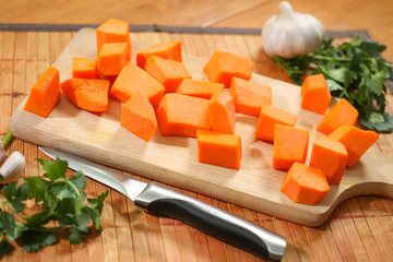 Raw pumpkin chopped on the cutting board