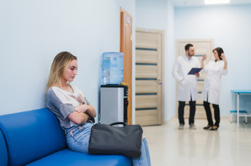 Woman patient waiting at hospital Doctors Waiting Room