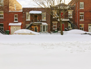Naklejka premium Snowy urban street with brick buildings