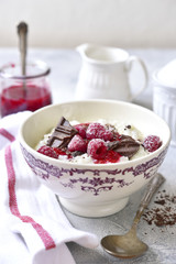 Rice porridge or pudding with berry syrup for a breakfast.