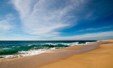 Beach under cirrus cloudscape at the Todos Santos artist community in central Baja California Mexico BCS